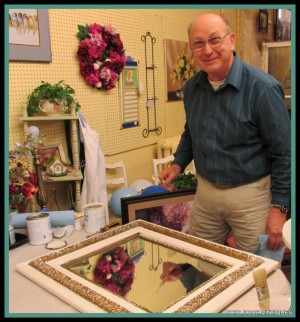 Donnie painting a mirror frame.